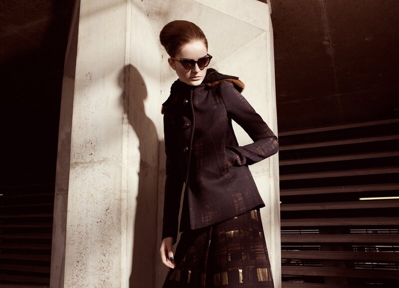 woman in coat and sunglasses