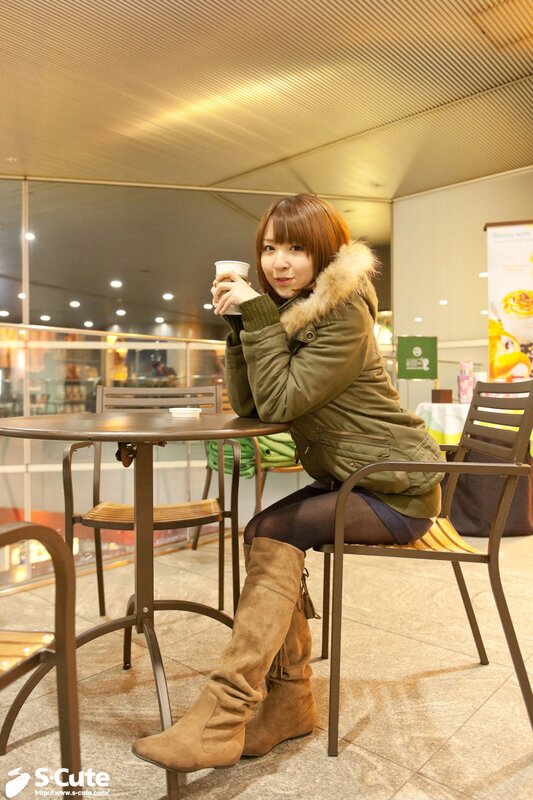 Woman in coat at cafe