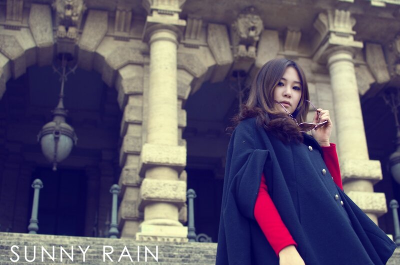 woman in coat at historic building