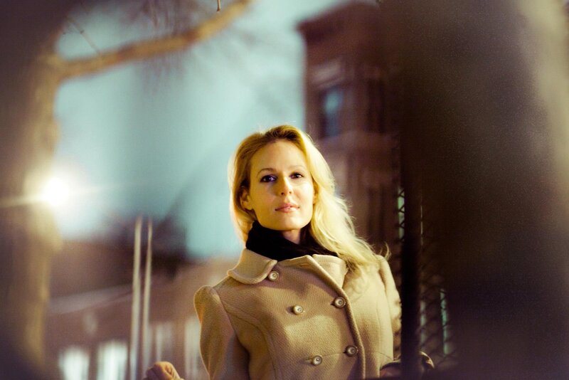 woman in coat at night