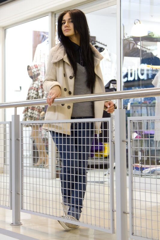 Woman in coat at shopping mall