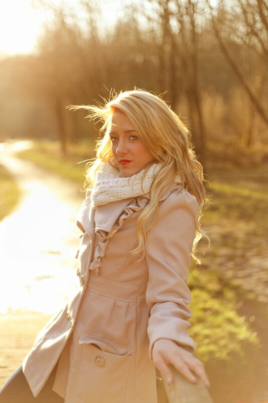woman in coat at sunset