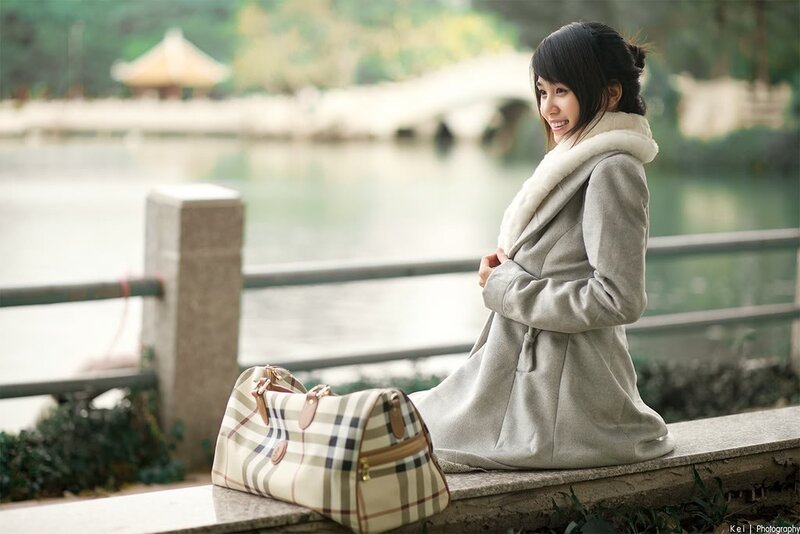 Woman in coat by lake