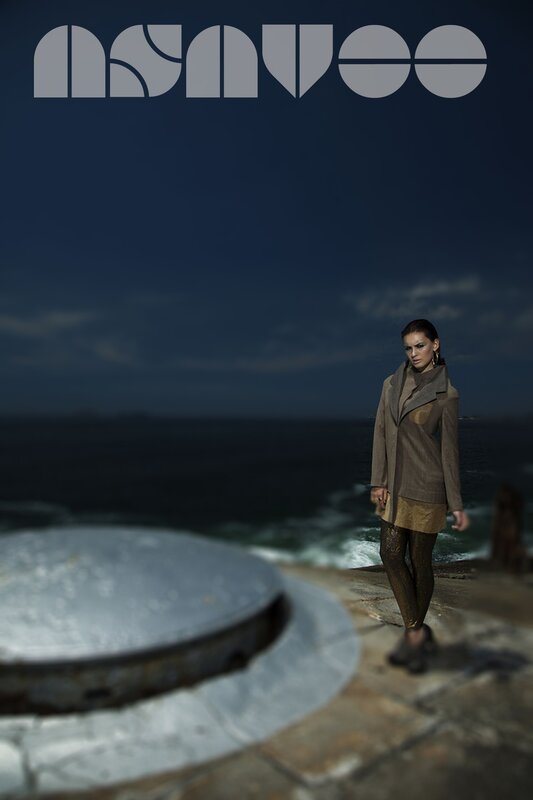 woman in coat by the sea