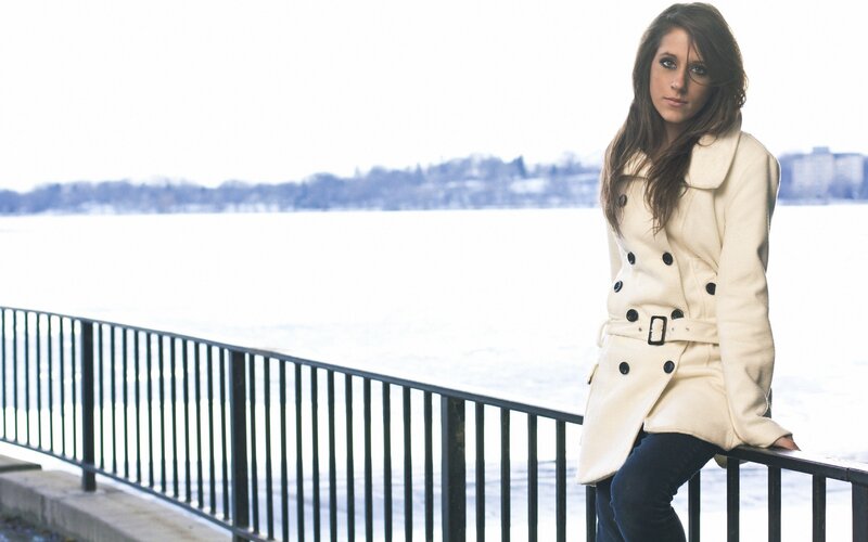 woman in coat by the water