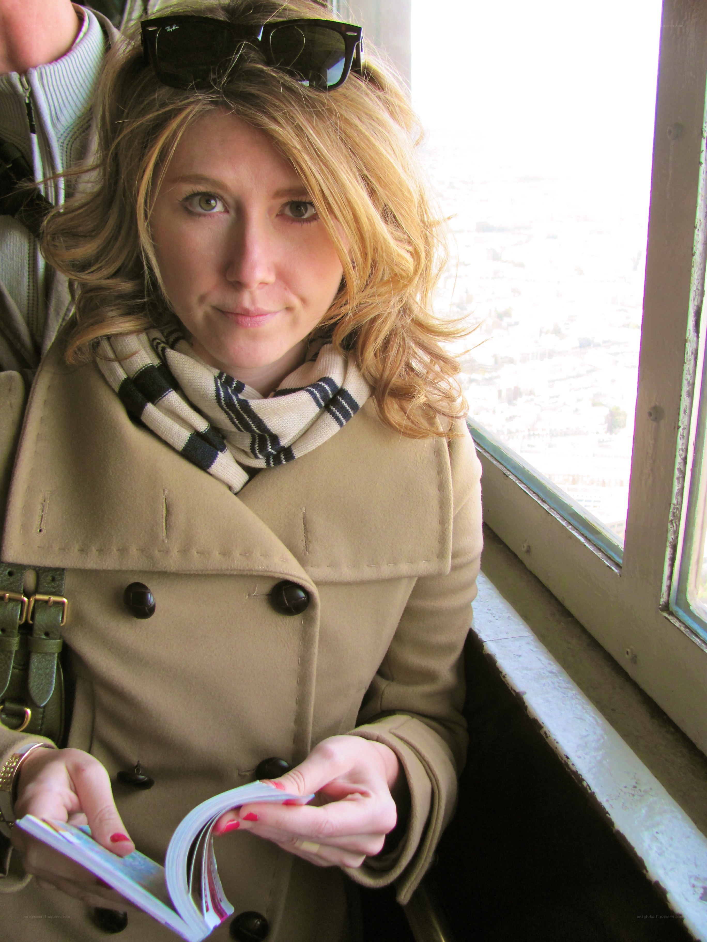 Woman in coat by window