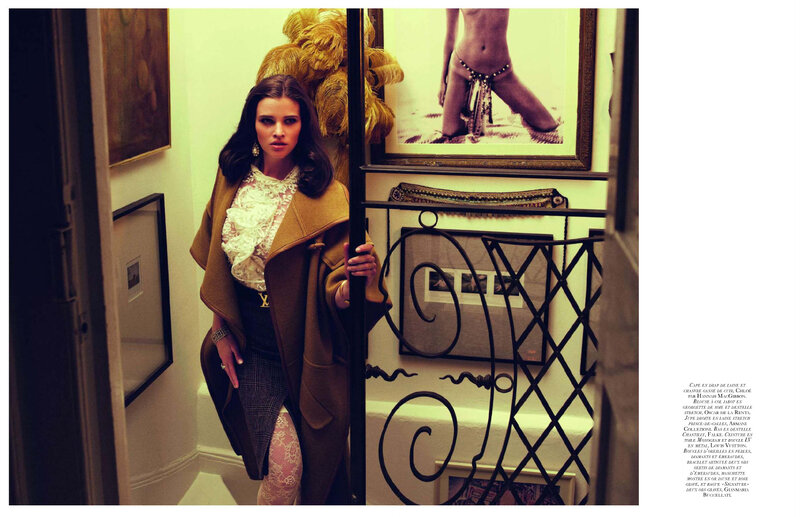 woman in coat holding door