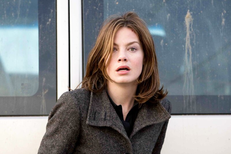 woman in coat looking surprised