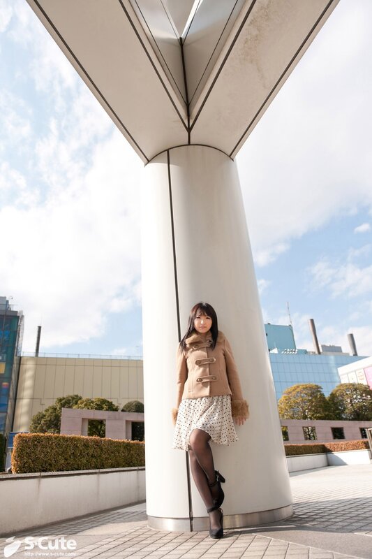 Woman in coat near pillar
