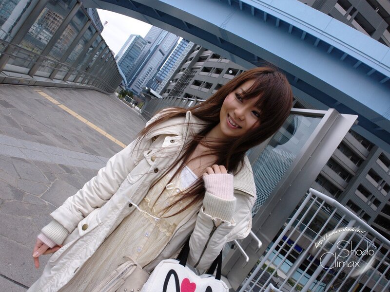 Woman in coat on city bridge
