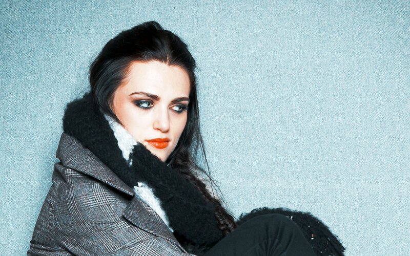 woman in coat with bold makeup