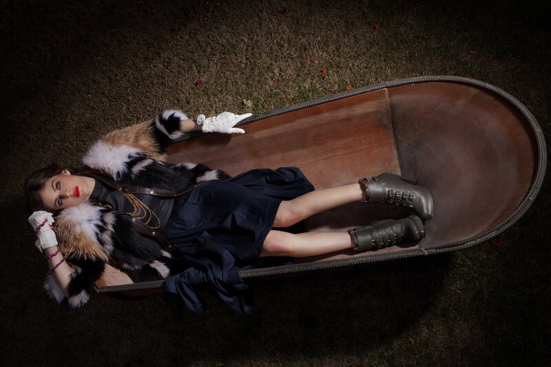 Woman in coffin on grass