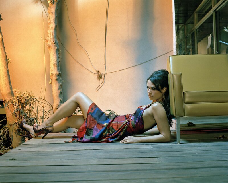 woman in colorful dress lying on deck