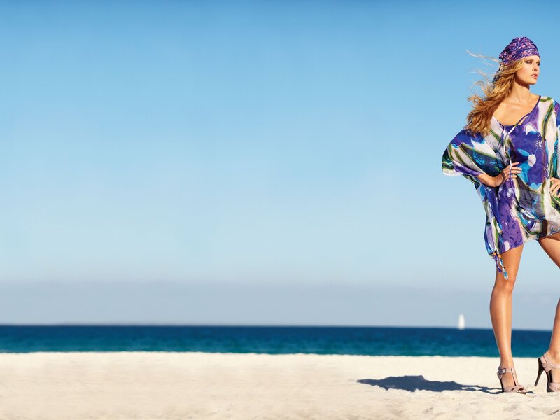 Woman in colorful dress on beach