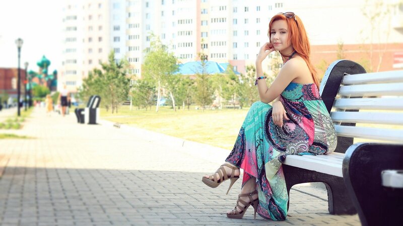 Woman in colorful dress on bench