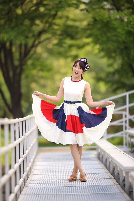 woman in colorful dress on bridge