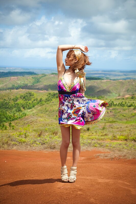 Woman in colorful dress on hilltop