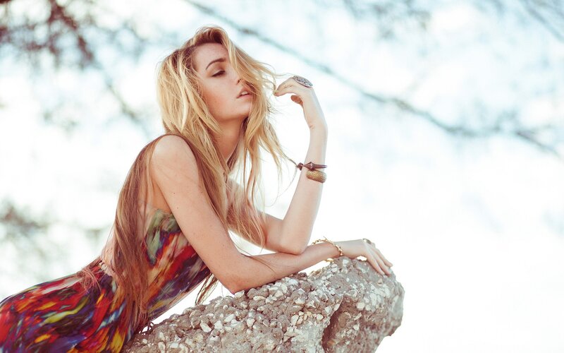 woman in colorful dress on rock