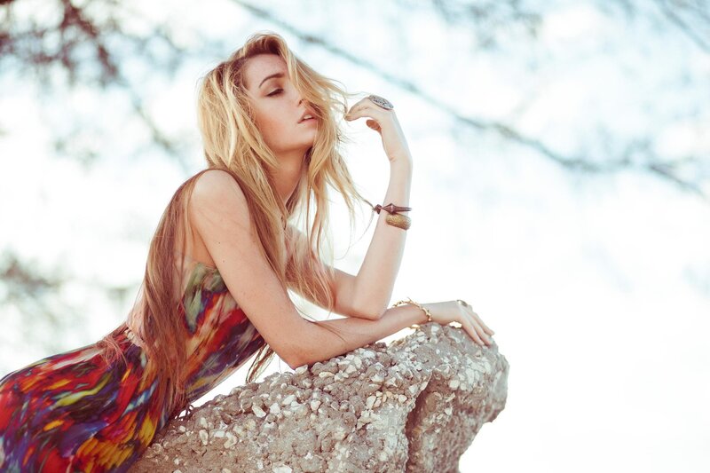 woman in colorful dress on rock