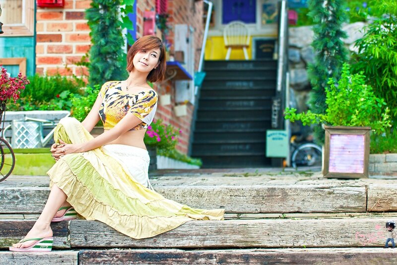 Woman in colorful dress sitting on steps