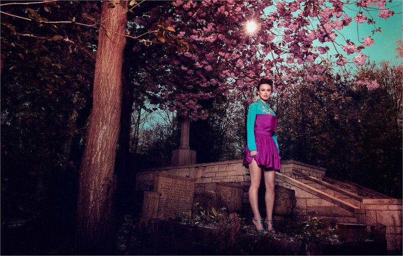 Woman in colorful dress under cherry blossoms