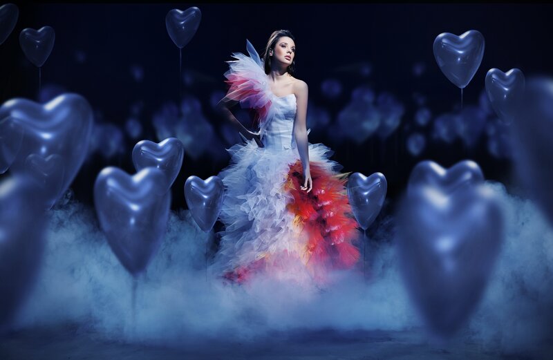 woman in colorful dress with heart balloons