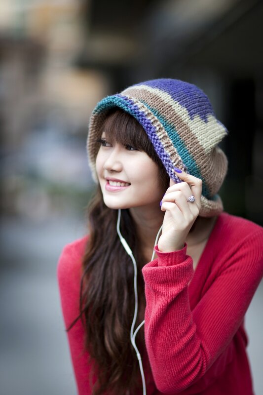 woman in colorful hat smiling