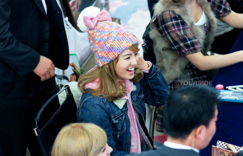 woman in colorful hat smiling