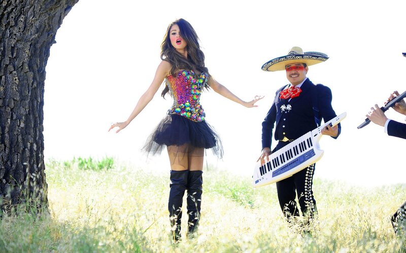 woman in colorful outfit with musicians