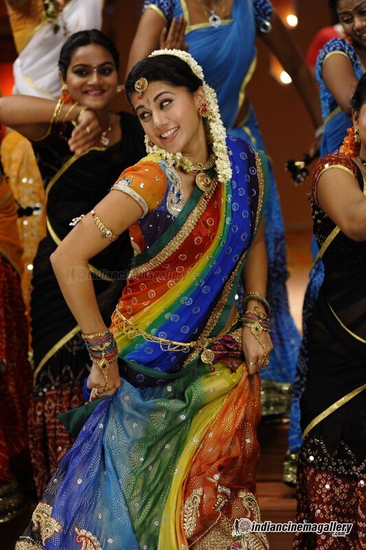 Woman in colorful sari dancing