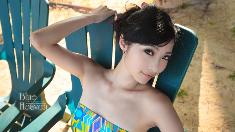 woman in colorful swimsuit on beach chair