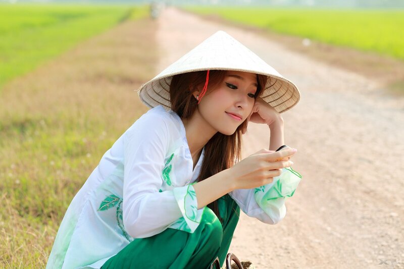 Woman in conical hat on rural path