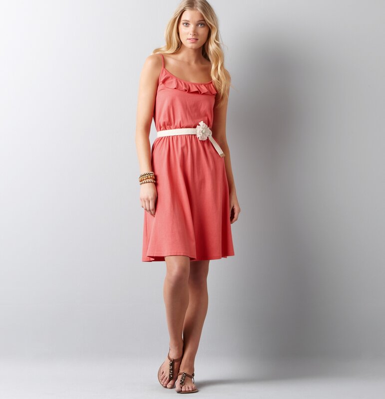 Woman in coral dress with belt