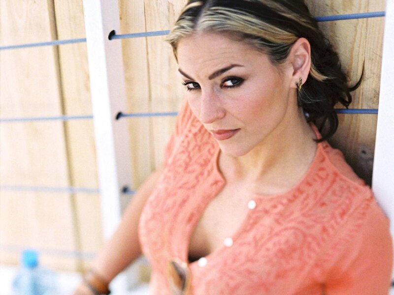 woman in coral top leaning