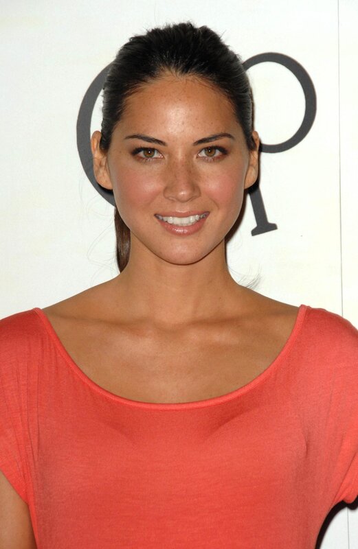 woman in coral top smiling