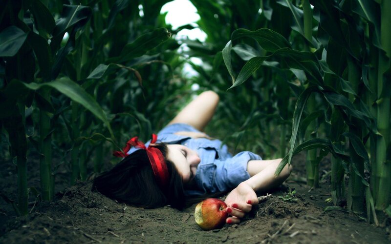 woman in cornfield with apple