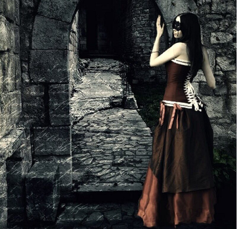 woman in corset at stone archway