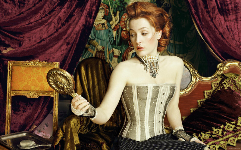woman in corset holding mirror