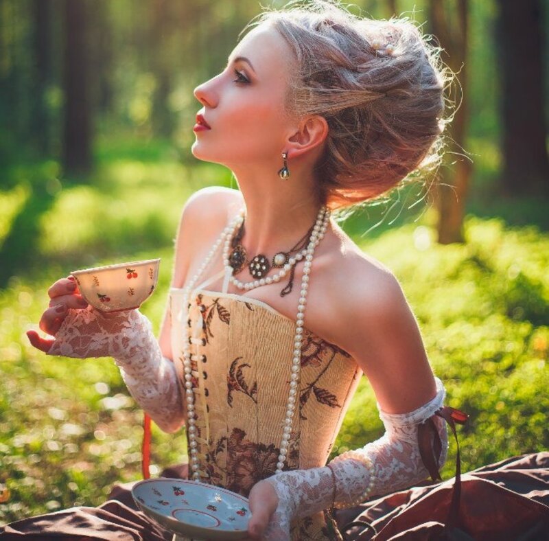 Woman in Corset Holding Tea Cup