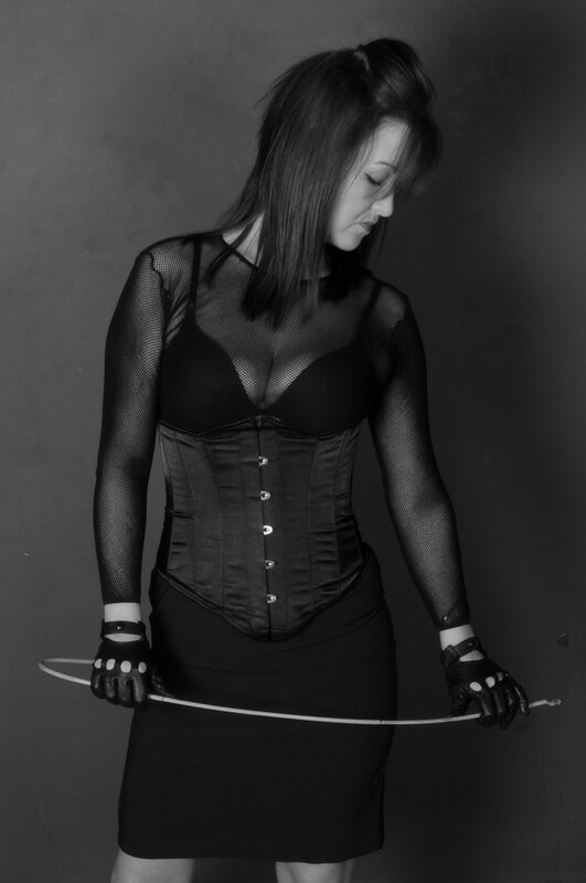 woman in corset holding whip