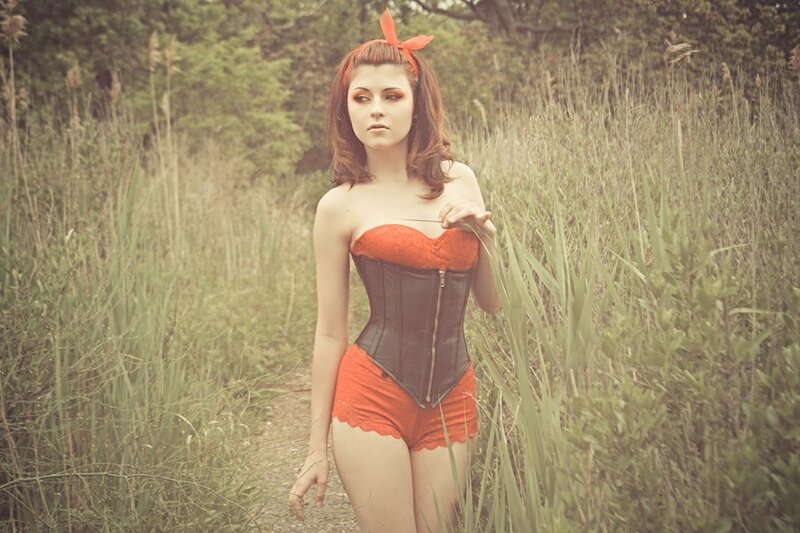 Woman in corset in a field