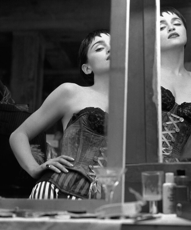 woman in corset looking at mirror