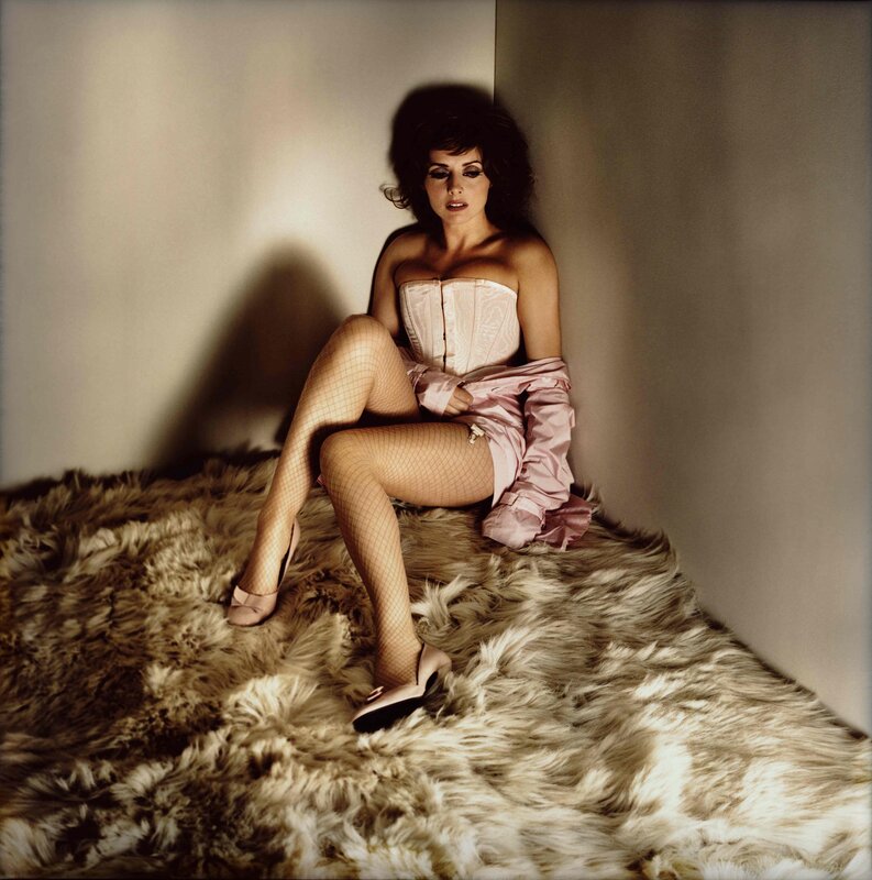 woman in corset sitting on rug