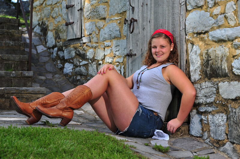 Woman in Cowboy Boots — Brown, Relaxed, Afternoon, Photograph, Stone Wall