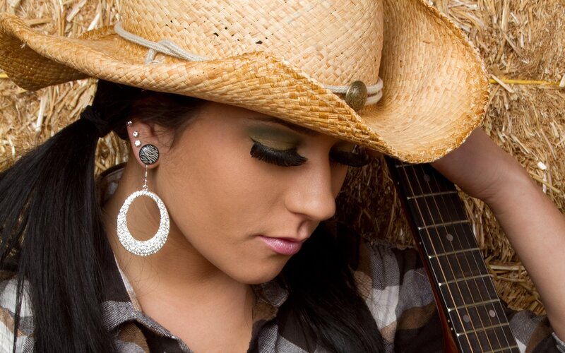 woman in cowboy hat with guitar