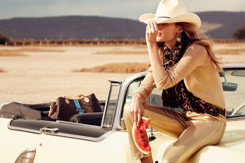 Woman in cowboy hat with watermelon