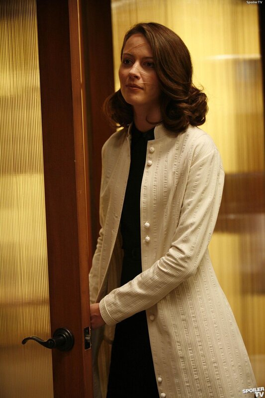 woman in cream coat standing