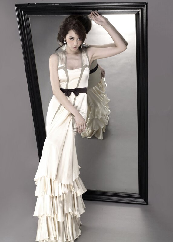 woman in cream dress by mirror