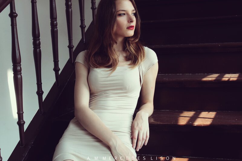 woman in cream dress on stairs