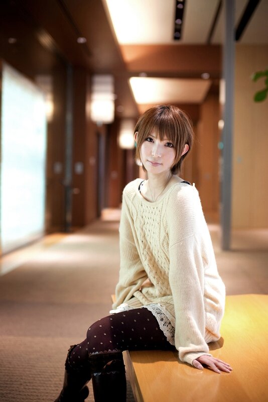 woman in cream sweater sitting